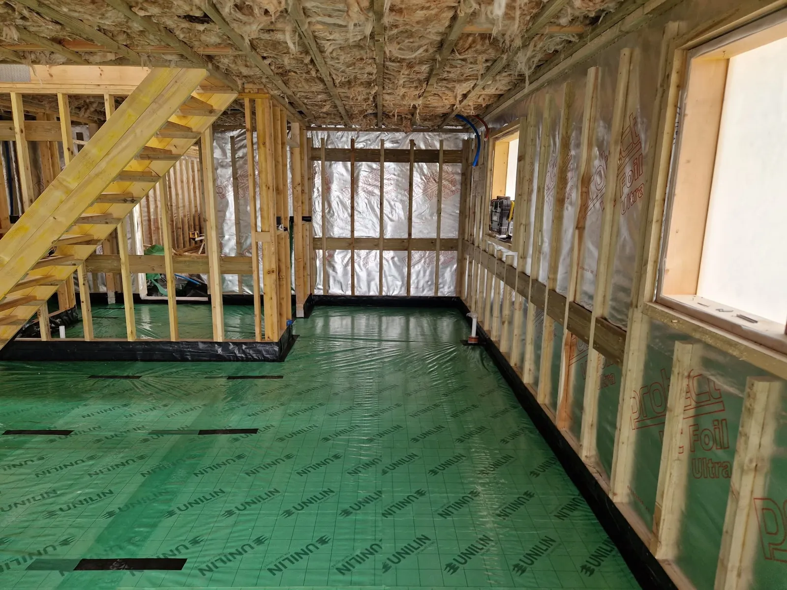Timber frame walls insulated, ready to board