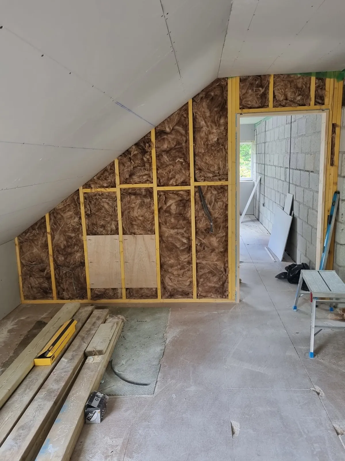 Insulated stud wall in a loft