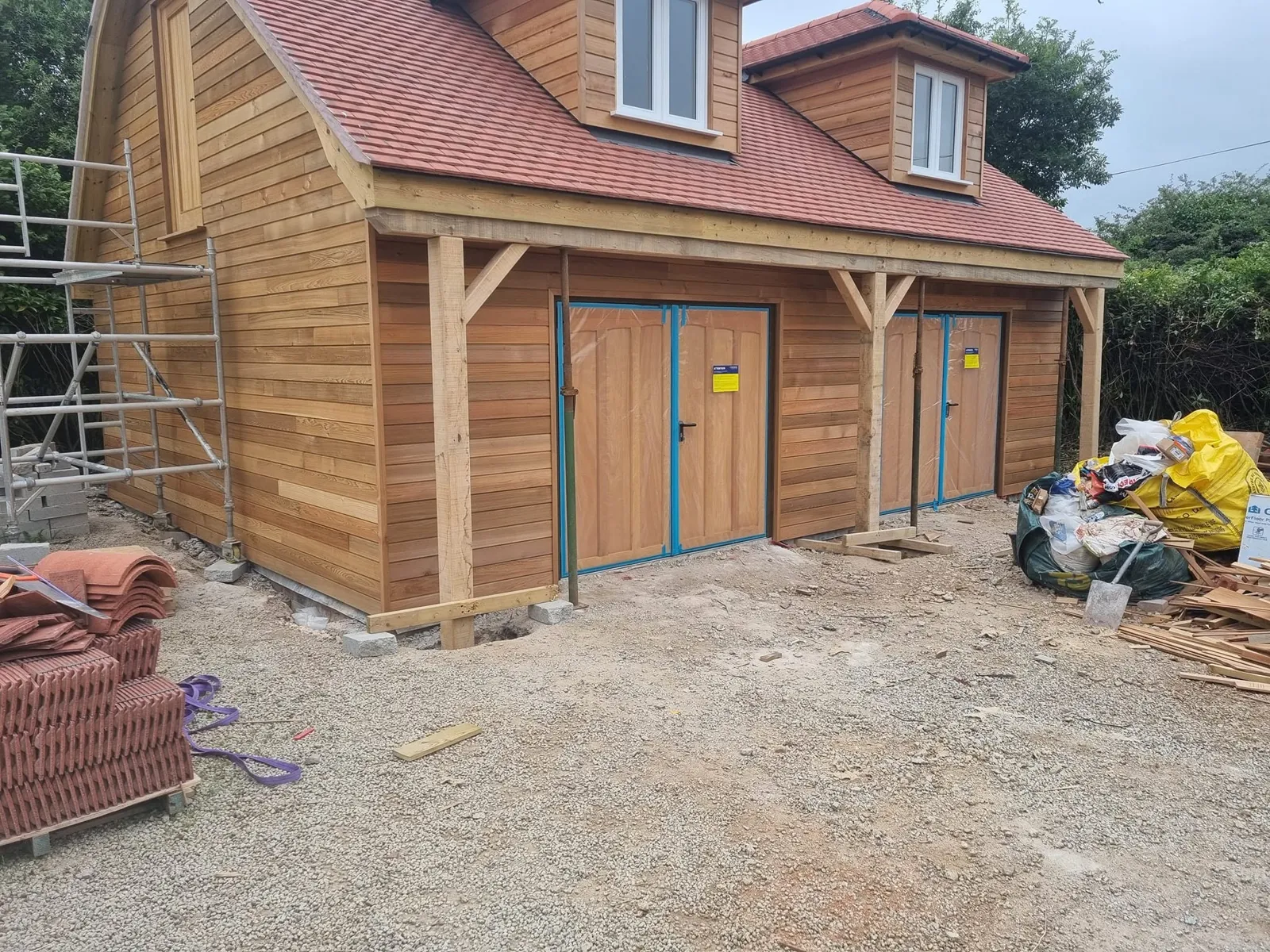 Timber-clad garage with dormer windows