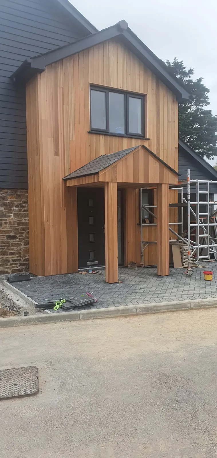 Timber-clad entrance with a porch